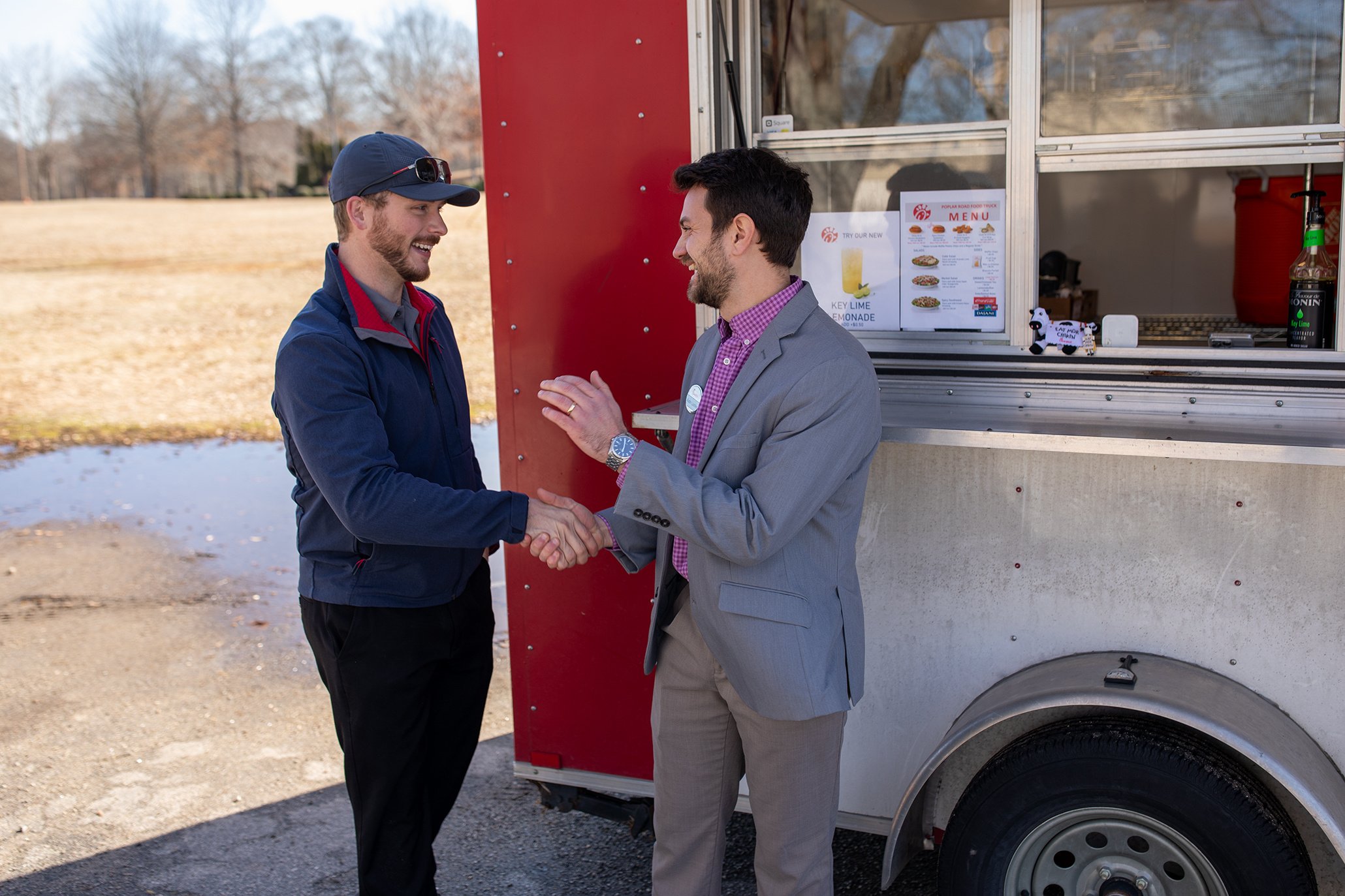 Team Members Shaking Hands at Food Truck